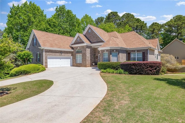 ranch-style house with brick siding, a front lawn, a garage, and concrete driveway