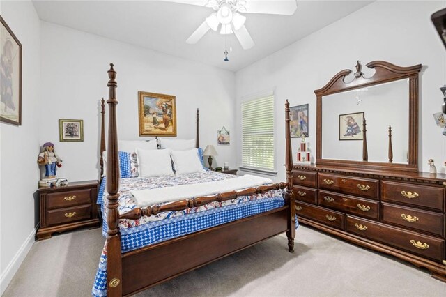 carpeted bedroom with ceiling fan and baseboards
