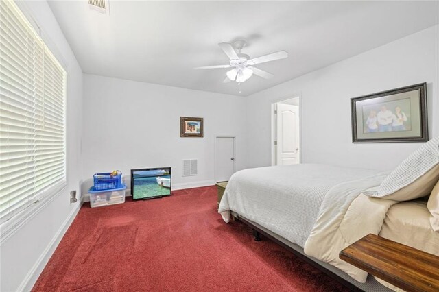 carpeted bedroom with multiple windows, baseboards, and ceiling fan