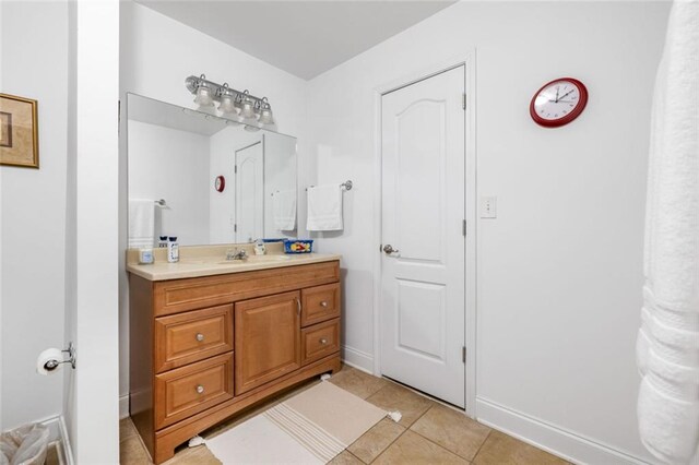 bathroom featuring tile patterned floors, vanity, and baseboards