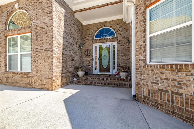 property entrance featuring brick siding