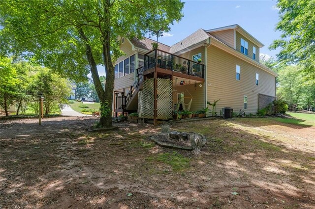 view of property exterior with central AC unit, a deck, and stairway