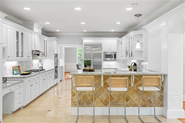 130 Robin Rd, Marietta, GA 30067 - kitchen featuring built in appliances, a peninsula, glass insert cabinets, backsplash, and light stone countertops