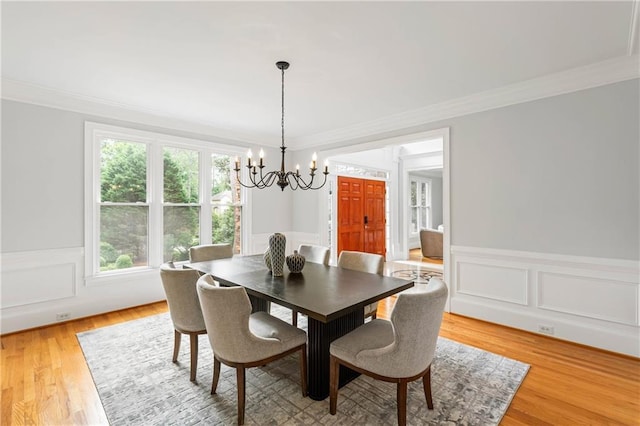 130 Robin Rd, Marietta, GA 30067 - dining area with a chandelier, ornamental molding, light wood-type flooring, wainscoting, and a decorative wall