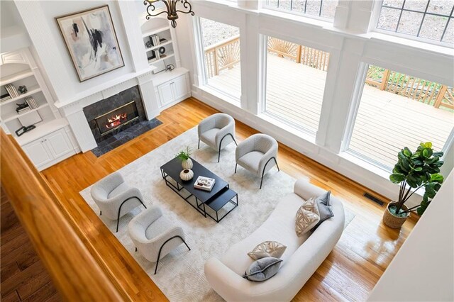 130 Robin Rd, Marietta, GA 30067 - living area with a tiled fireplace, light wood finished floors, and built in shelves