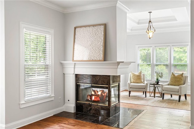 130 Robin Rd, Marietta, GA 30067 - living room featuring healthy amount of natural light, baseboards, ornamental molding, wood finished floors, and a tiled fireplace