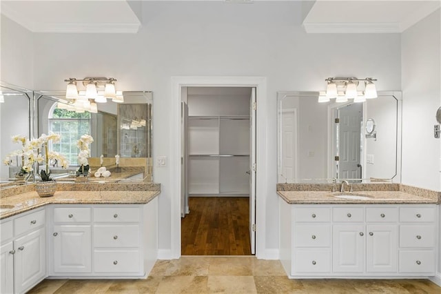 130 Robin Rd, Marietta, GA 30067 - bathroom with crown molding, a shower stall, two vanities, a spacious closet, and baseboards