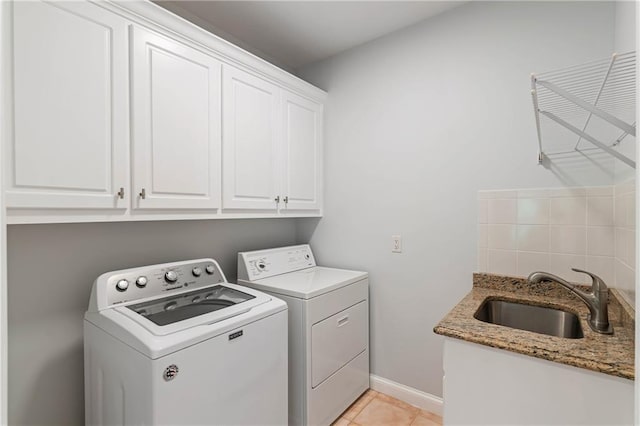 130 Robin Rd, Marietta, GA 30067 - laundry area with washing machine and dryer, cabinet space, light tile patterned floors, and baseboards