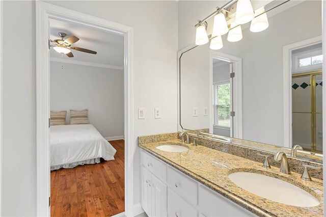 130 Robin Rd, Marietta, GA 30067 - bathroom with ornamental molding, wood finished floors, ceiling fan, baseboards, and double vanity