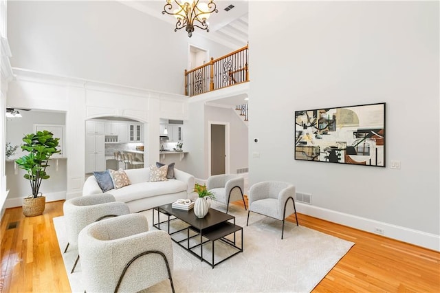 130 Robin Rd, Marietta, GA 30067 - living area with wood finished floors, a towering ceiling, baseboards, and arched walkways