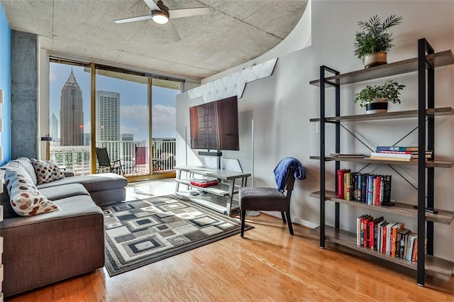 interior space featuring light hardwood / wood-style floors, floor to ceiling windows, and ceiling fan