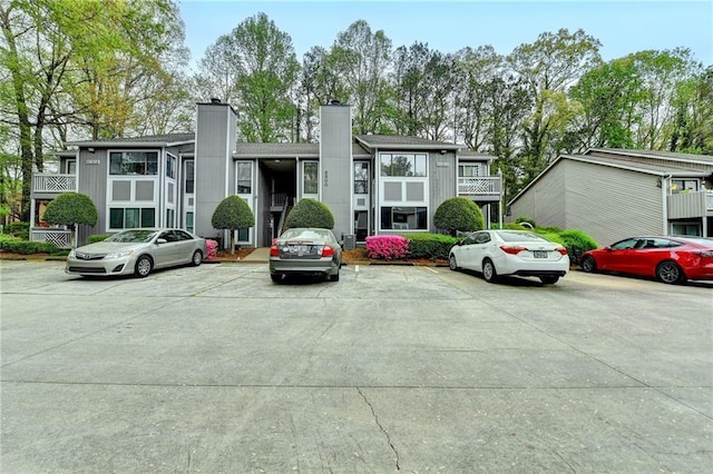 view of building exterior with uncovered parking