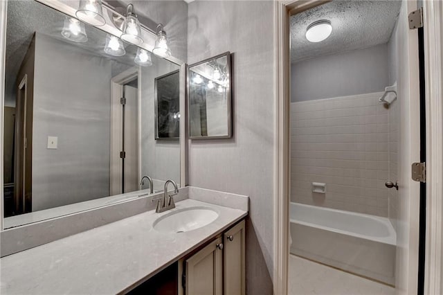 bathroom with vanity, shower / bath combination, and a textured ceiling