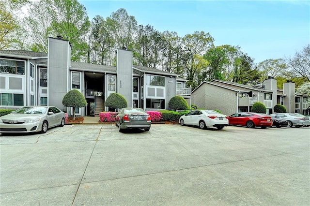 view of building exterior with uncovered parking