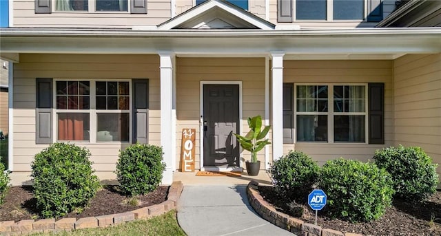 view of exterior entry featuring a porch