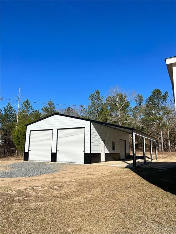 view of outbuilding featuring a garage and a carport