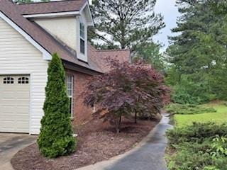 view of side of home with driveway