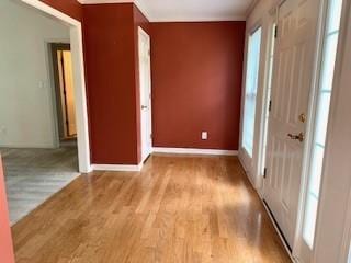 spare room featuring wood finished floors and baseboards