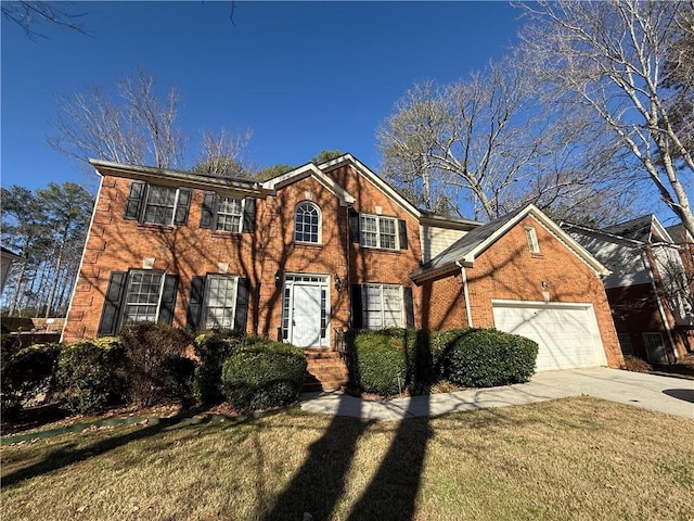 colonial home featuring an attached garage, a front lawn, concrete driveway, and brick siding