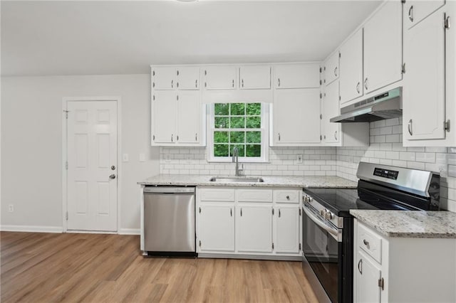 kitchen featuring a sink, under cabinet range hood, appliances with stainless steel finishes, light wood-style flooring, and white cabinetry