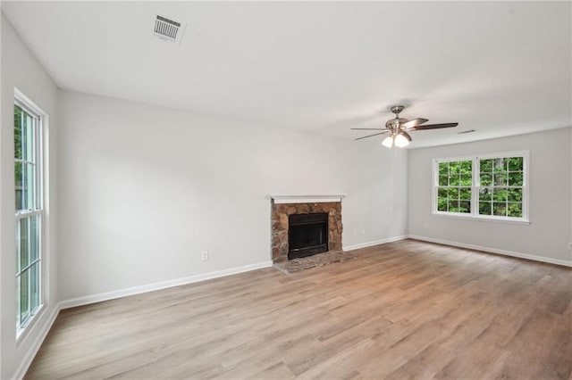 unfurnished living room featuring baseboards, a ceiling fan, visible vents, and light wood-style flooring