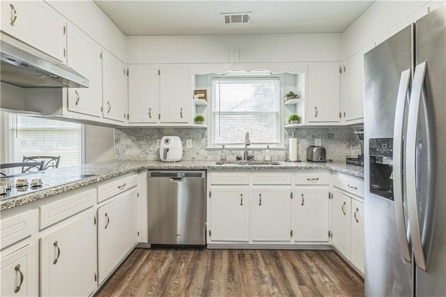 kitchen featuring appliances with stainless steel finishes, a sink, open shelves, white cabinetry, and dark wood-type flooring