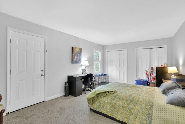 bedroom featuring two closets and carpet