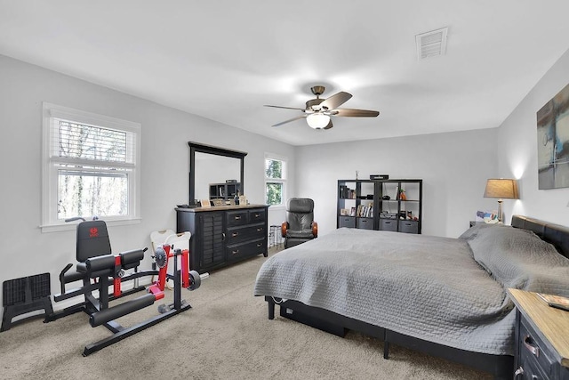 bedroom featuring light carpet and ceiling fan