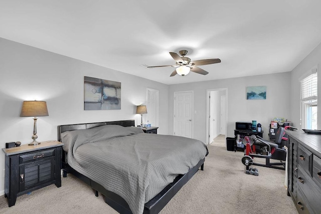 bedroom featuring light colored carpet and ceiling fan