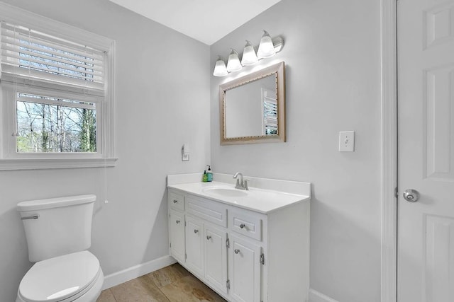 bathroom featuring toilet and vanity