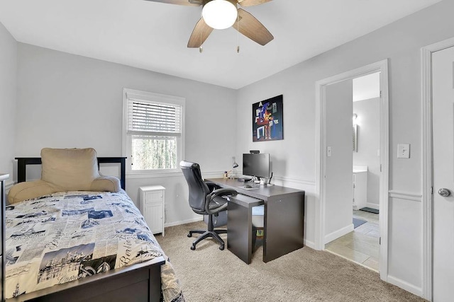 bedroom featuring ceiling fan, ensuite bath, and light carpet