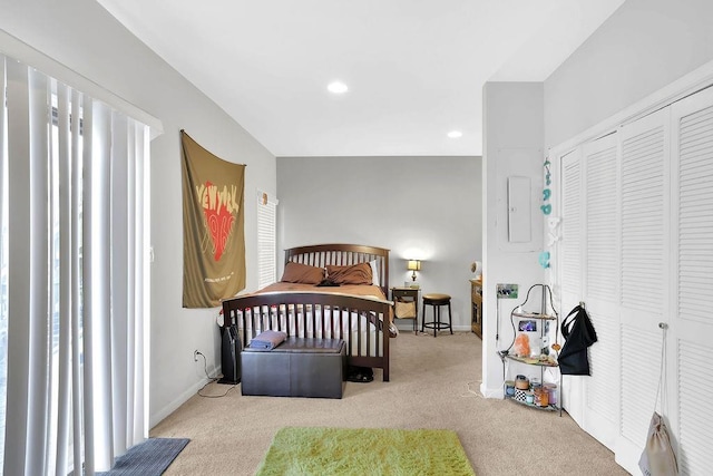 bedroom featuring a closet and light carpet