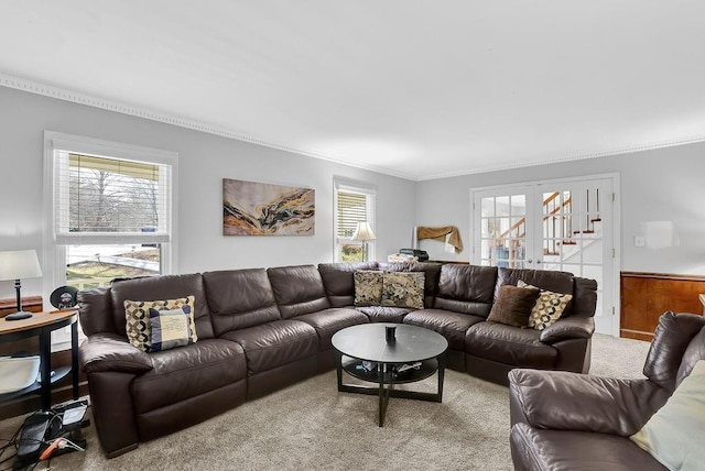 carpeted living room with ornamental molding and wood walls