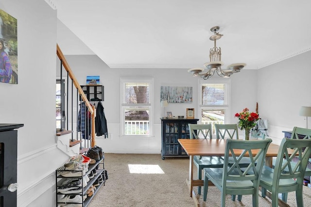 dining area with an inviting chandelier and carpet floors