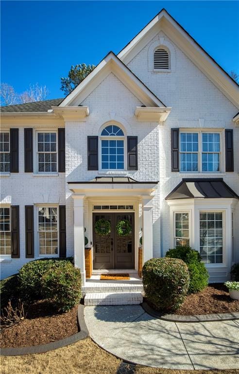 view of front of house with french doors and brick siding