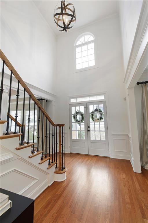 entrance foyer with a decorative wall, stairway, and light wood-style floors