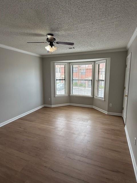 363 Mount Vernon Dr, Calhoun, GA 30701 - unfurnished room featuring ornamental molding, healthy amount of natural light, a textured ceiling, wood finished floors, and a ceiling fan