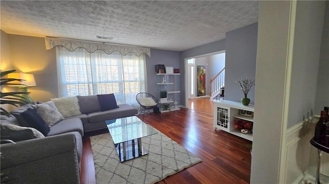 living room featuring hardwood / wood-style floors and a textured ceiling