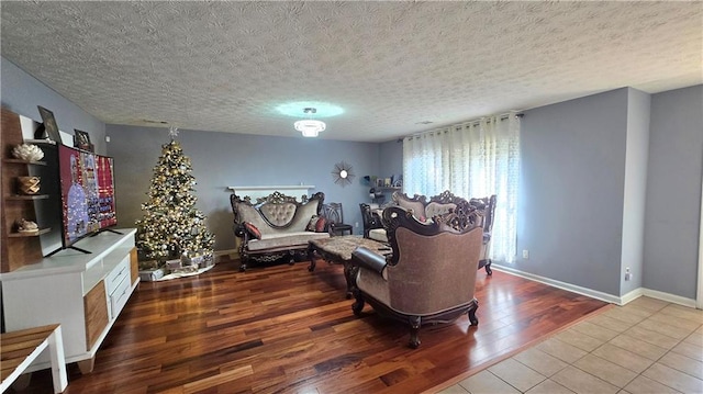 living room with hardwood / wood-style flooring and a textured ceiling