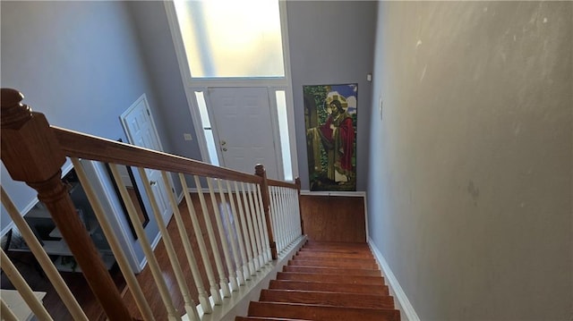 stairway featuring a high ceiling