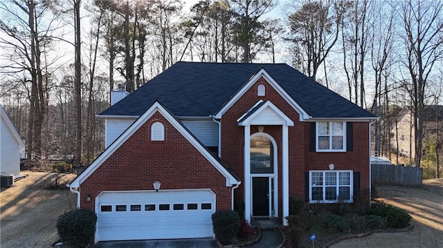 front of property featuring a garage and central AC unit