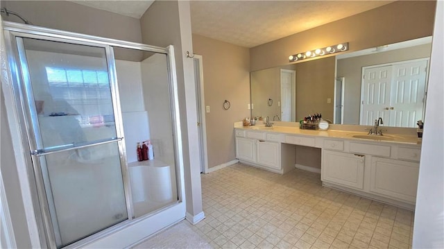 bathroom featuring vanity and a shower with shower door