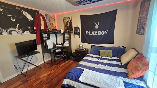 bedroom featuring dark hardwood / wood-style floors and a textured ceiling