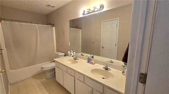 full bathroom with vanity, shower / bathtub combination with curtain, a textured ceiling, and toilet