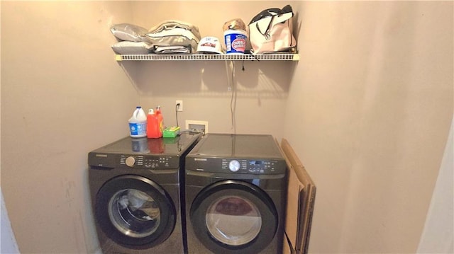 laundry room with washing machine and clothes dryer