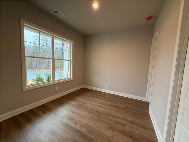 spare room with dark wood-type flooring