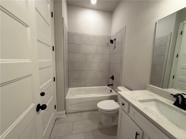 full bathroom featuring tiled shower / bath, vanity, tile patterned floors, and toilet