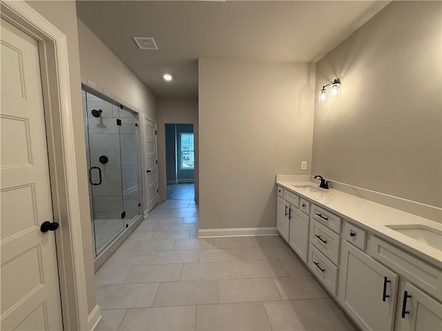 bathroom featuring vanity, tile patterned floors, and walk in shower