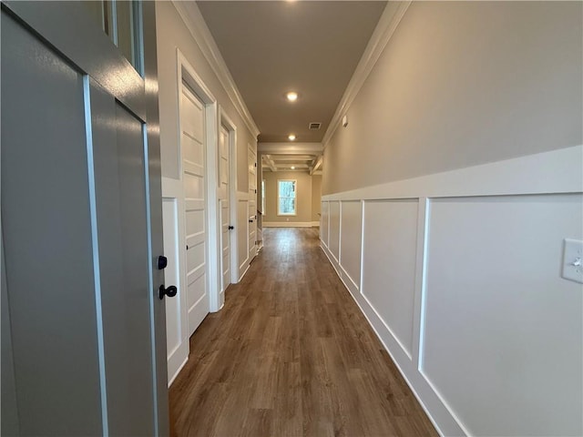 hallway with ornamental molding and dark hardwood / wood-style floors