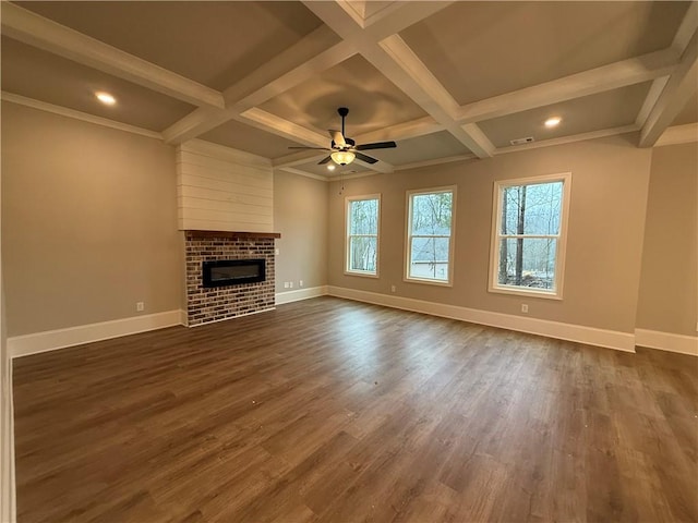 unfurnished living room featuring a brick fireplace, coffered ceiling, and dark hardwood / wood-style floors